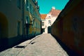 Old medieval Narrow Street in Tallinn with shabby walls , Estonia Royalty Free Stock Photo